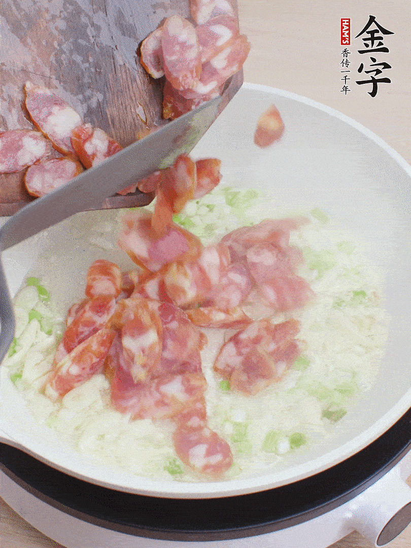 油5成熱，蒜末、蔥白爆香，下香腸炒出香味。